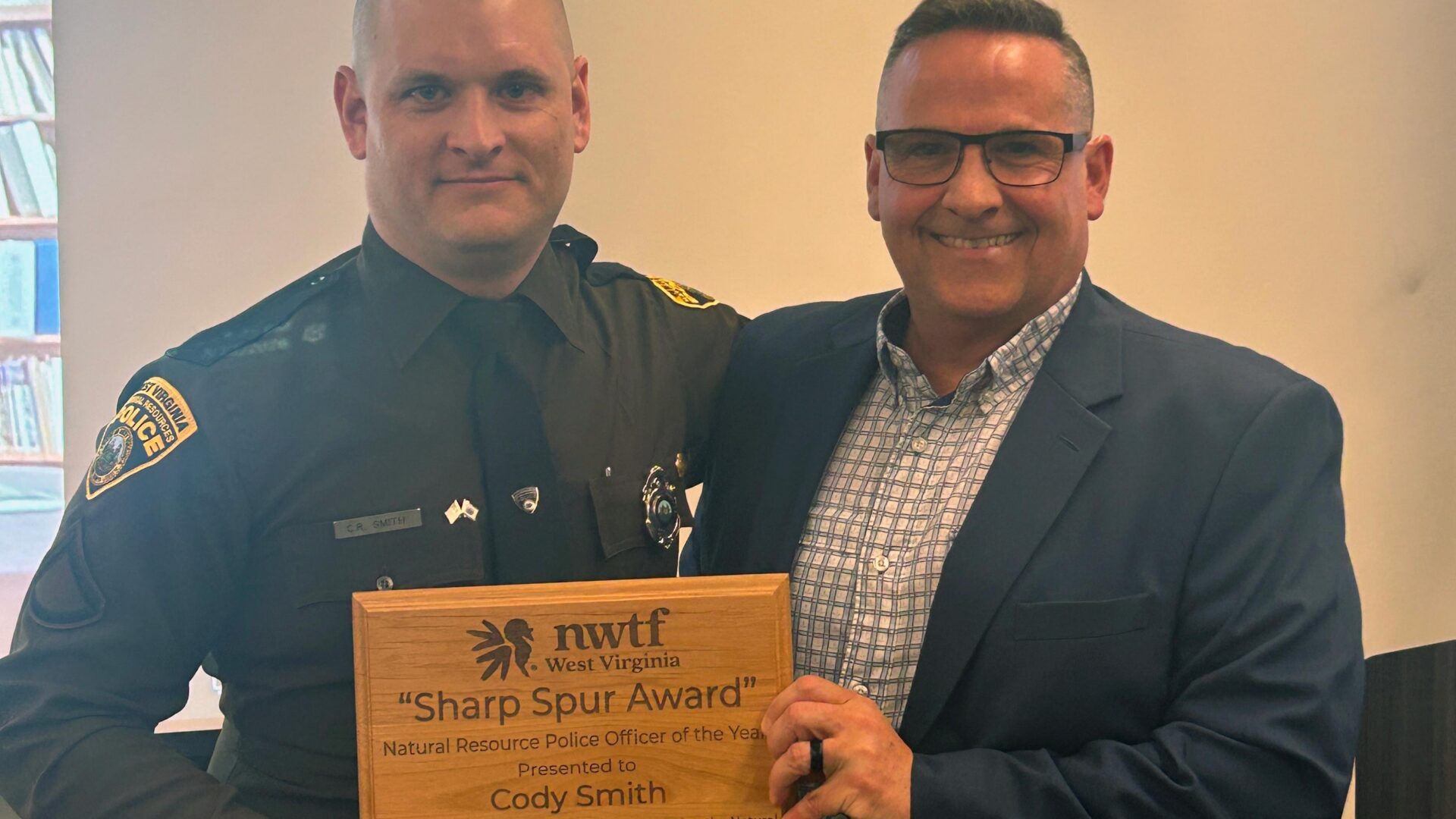 WVDNR natural resources police officer Cody Smith receives National Wild Turkey Federation's Sharp Spur Award.