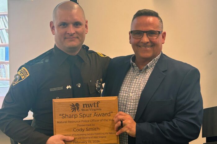 WVDNR natural resources police officer Cody Smith receives National Wild Turkey Federation's Sharp Spur Award.